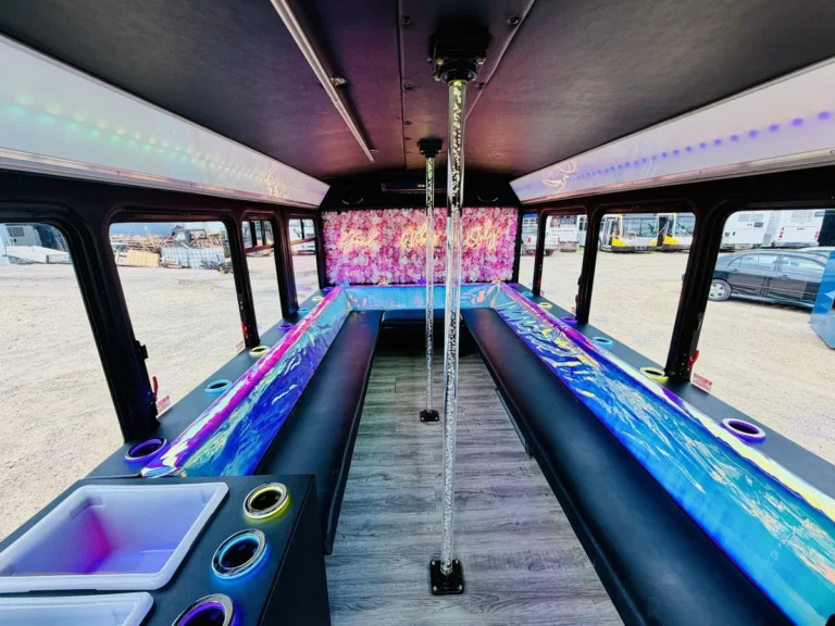 Full-length aisle view inside The Mini Unicorn 15-passenger party bus