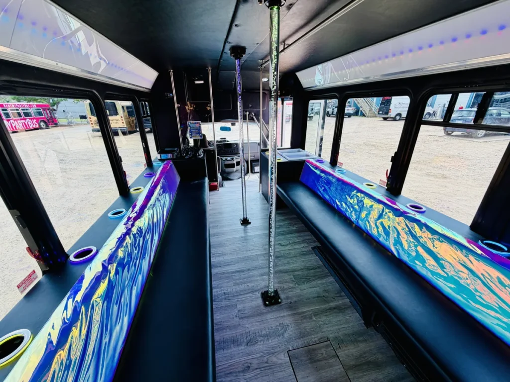 Dance floor and spinning poles inside a Rent My Party Bus mini bus set up for a school dance