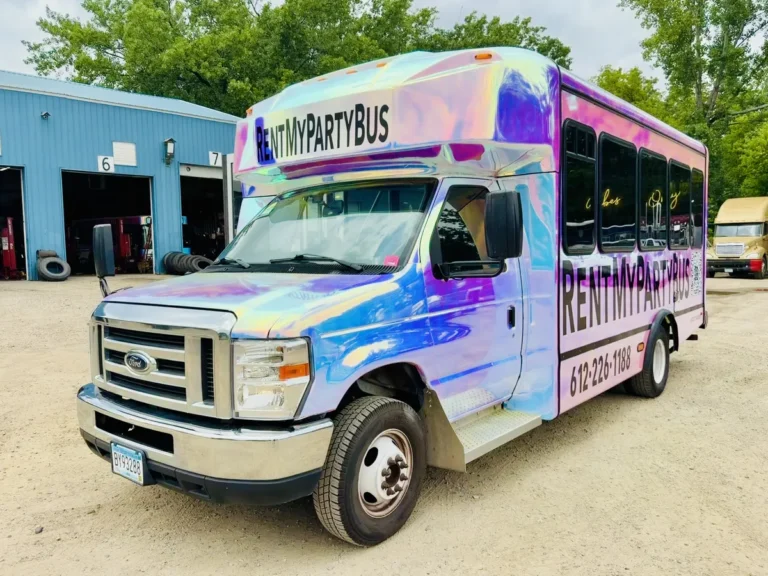 Front three-quarter view of The Mini Unicorn mini party bus with chrome unicorn wrap